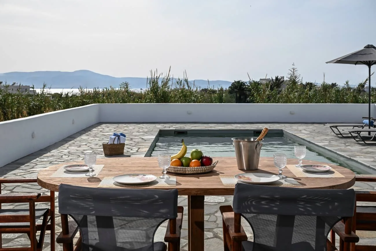 A quiet poolside dining terrace overlooking the Naxian landscape