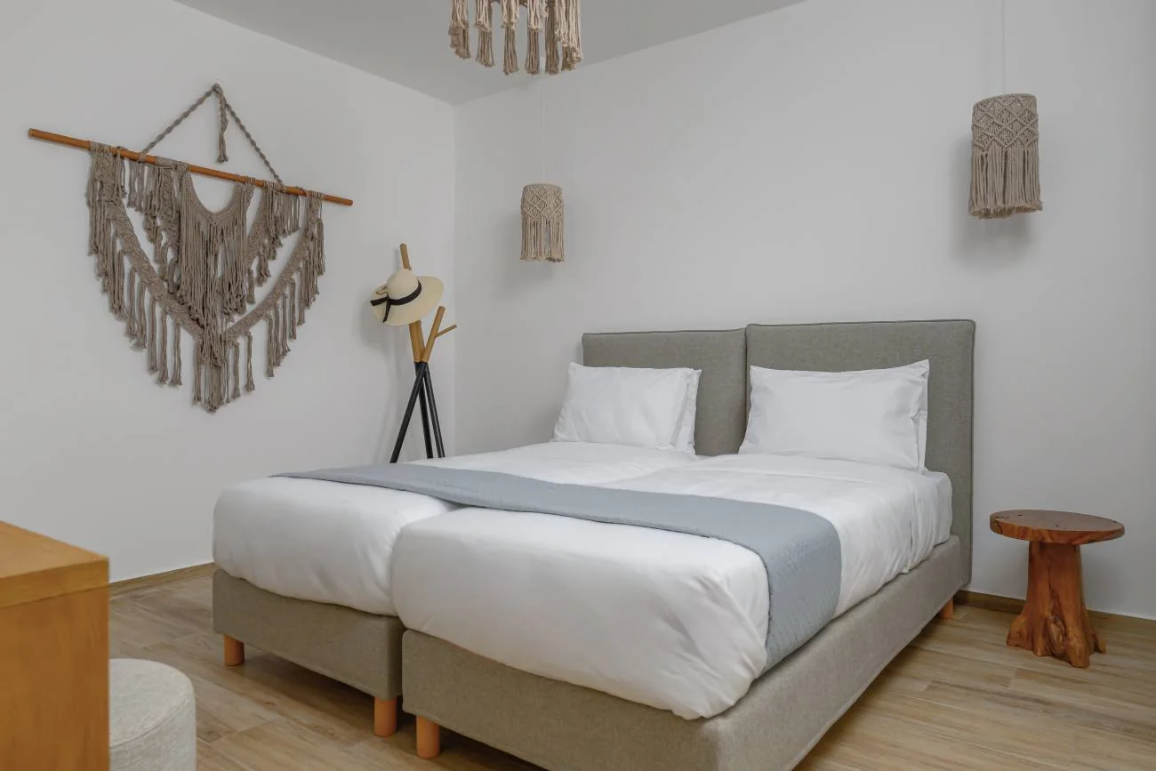 Bedroom with a double bed and woven wall art