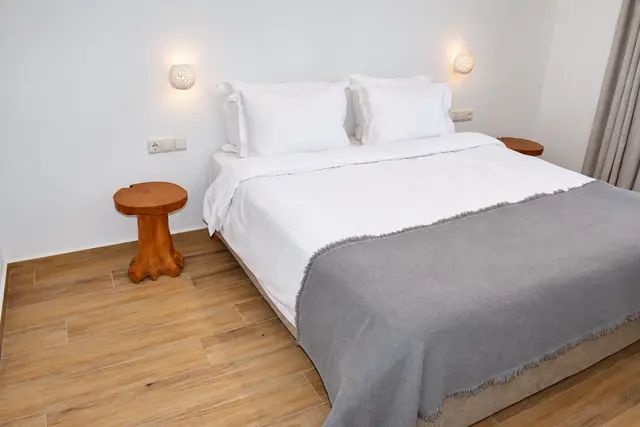 Double bedroom with natural wood furnishings