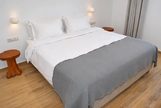 Double bedroom with natural wood furnishings