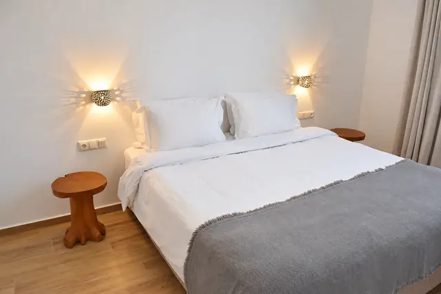 Double bedroom with natural wood furnishings