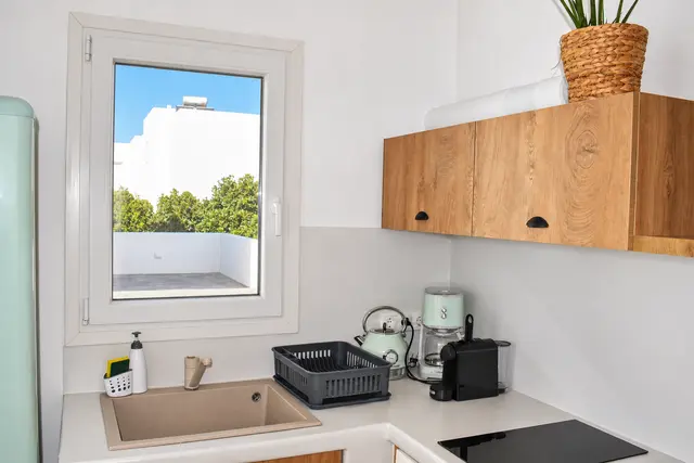 Private kitchenette with wooden cabinetry
