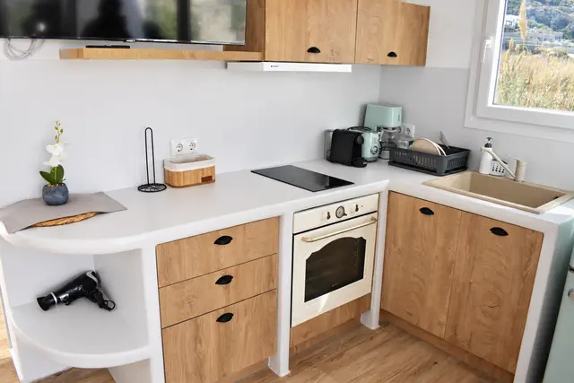Private kitchenette with wooden cabinetry
