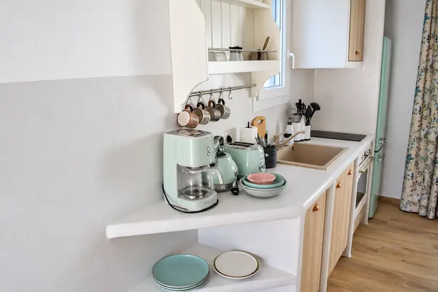Private kitchenette with wooden cabinetry